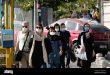 iranian-people-wearing-protective-face-masks-walk-along-an-avenue-in-northern-tehran-following-the-new-coronavirus-covid-19-